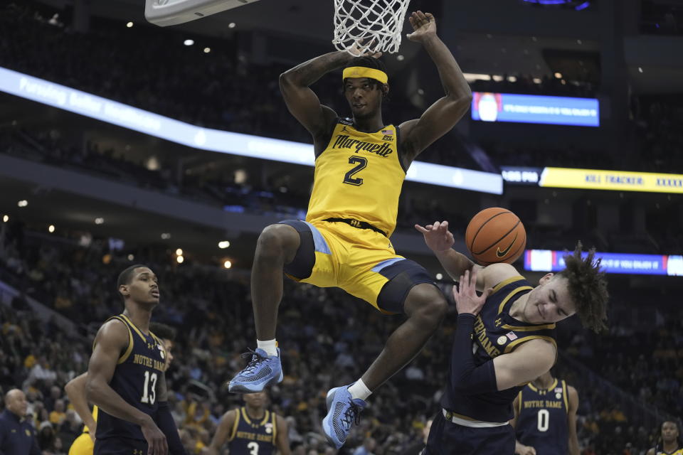 Marquette's Chase Ross dunks over Notre Dame's Braeden Shrewsberry during the first half of an NCAA college basketball game Saturday, Dec. 9, 2023, in Milwaukee. (AP Photo/Morry Gash)