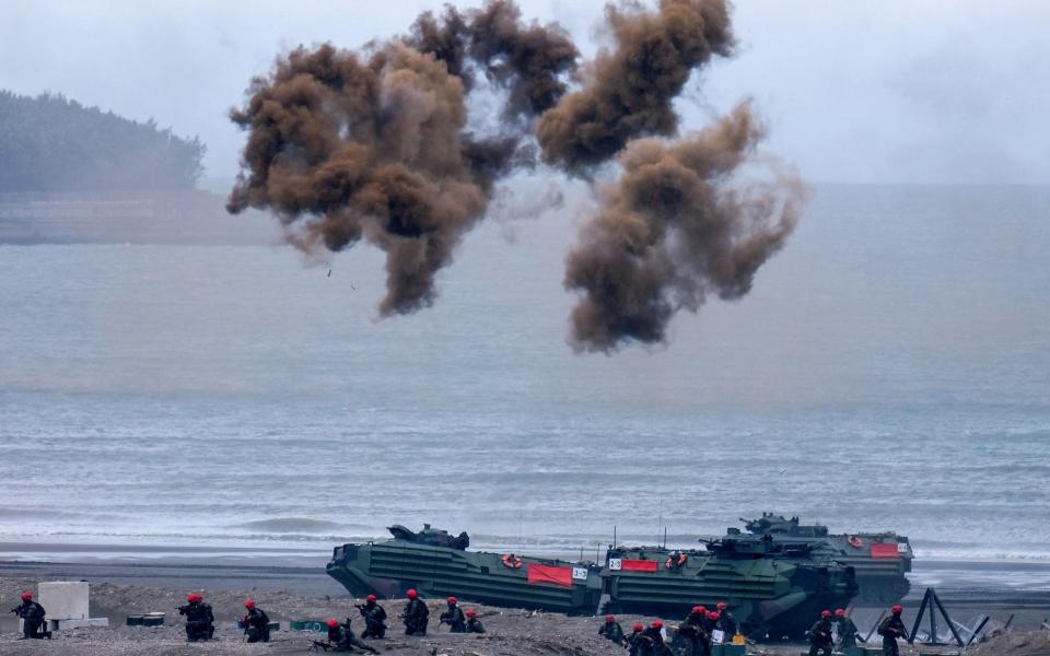 Armed vehicles and Taiwan military soldiers attend the annual Han Guang anti-landing drill at Bali beach