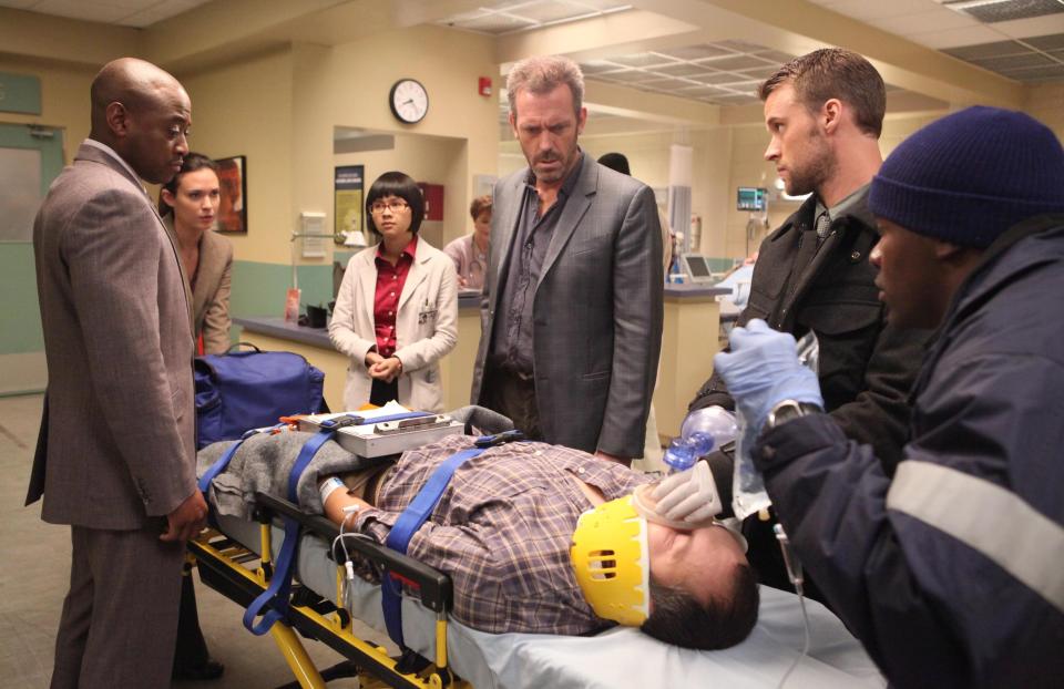 In this image released by Fox, standing from left, Omar Epps, Odette Annable, Charlyne Yi, Hugh Laurie and Jesse Spencer are shown in a scene from the final season of "House, M.D." The Fox medical drama concludes its eight-season run on Monday, May 21, 2012, with a finale at 9 p.m. EDT, preceded by a one-hour retrospective. (AP Photo/Fox, Adam Taylor)