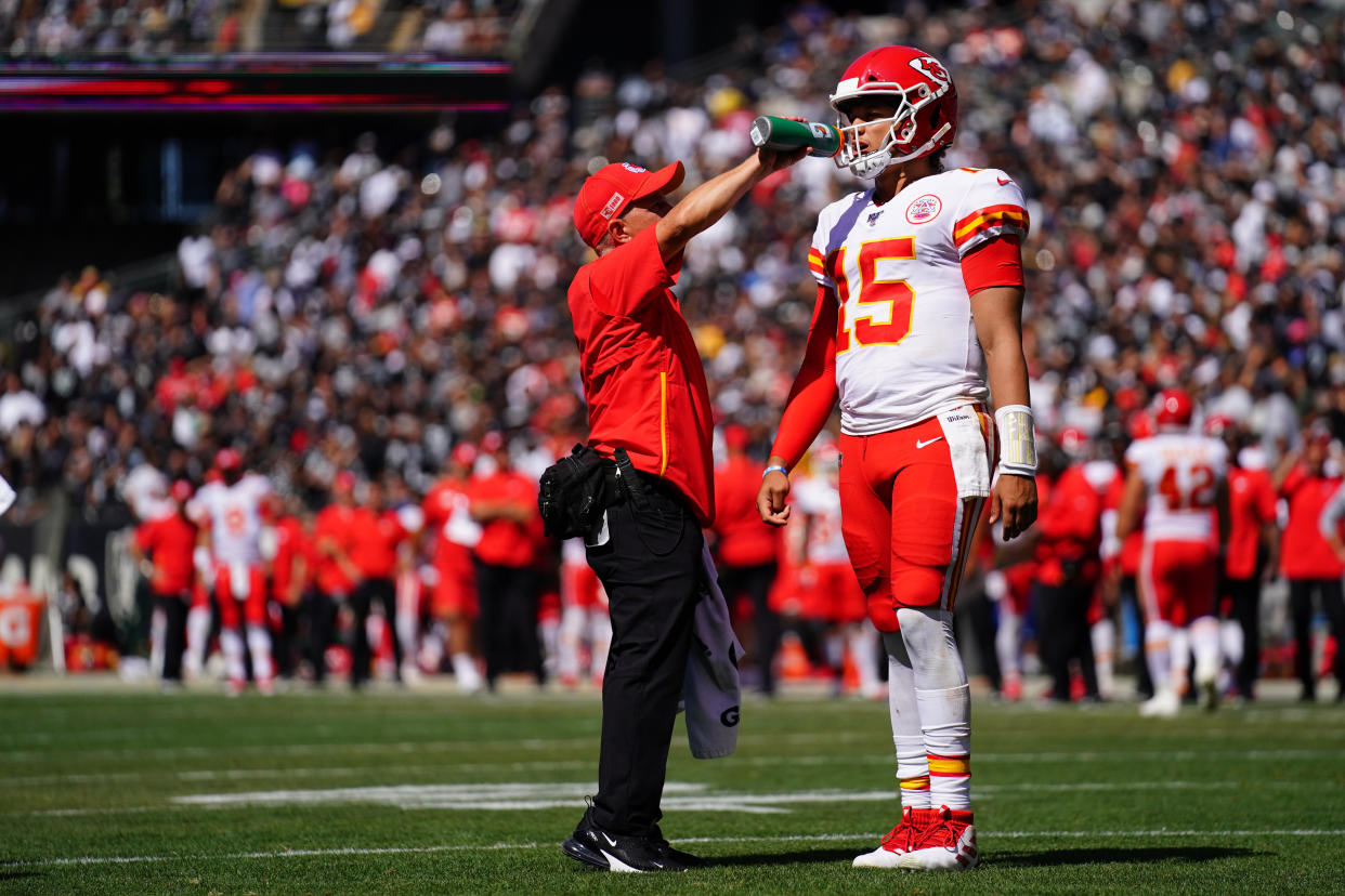 OAKLAND, CALIFORNIA - SEPTEMBER 15: Patrick Mahomes #15 of the Kansas City Chiefs is given a drink of water during the game against the Oakland Raiders at RingCentral Coliseum on September 15, 2019 in Oakland, California. (Photo by Daniel Shirey/Getty Images)