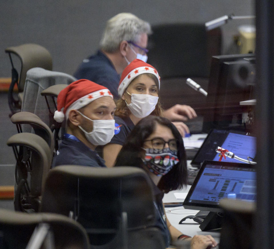 Launch teams monitor the countdown to the launch of Arianespace's Ariane 5 rocket carrying NASA's James Webb Space Telescope, Saturday, Dec. 25, 2021, in the Jupiter Center at the Guiana Space Center in Kourou, French Guiana. The world's largest and most powerful space telescope has blasted off on a high-stakes quest to behold light from the first stars and galaxies. NASA's James Webb Space Telescope rocketed away Saturday from French Guiana in South America. (NASA/Bill Ingalls/NASA via AP)