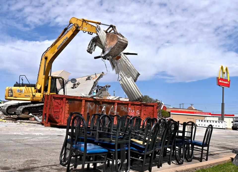 Tin is dropped into a bin as the Buffalo Gap Road McDonald’s restaurant is demolished Tuesday March 19, 2024. A newly-redesigned McDonald’s will be built on the site.