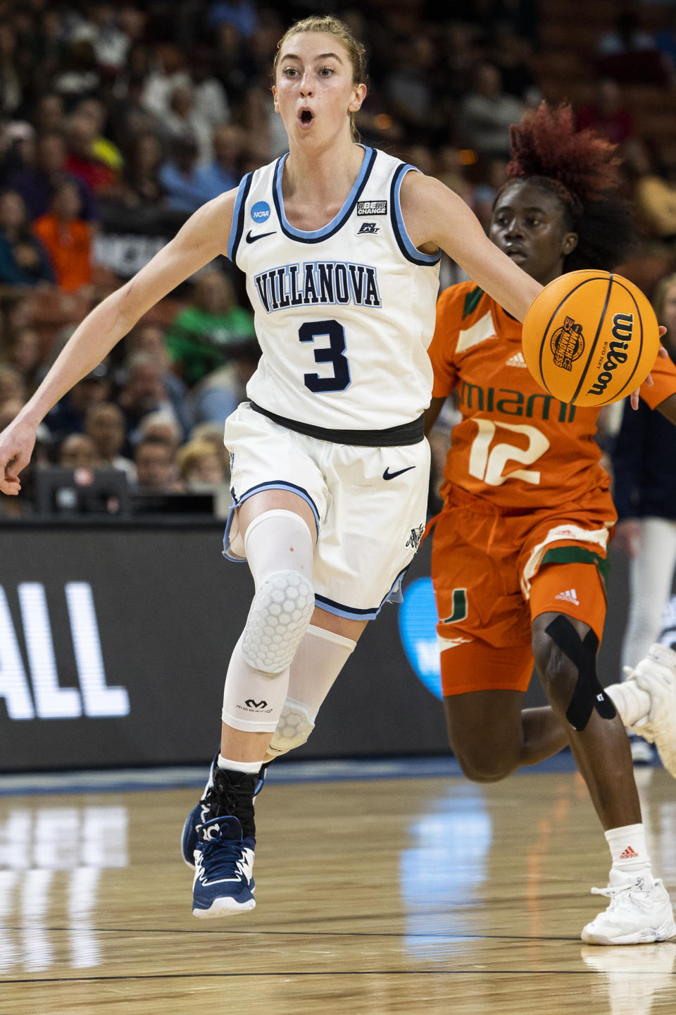 Villanova's Lucy Olsen (3) drives to the basket against Miami's Ja'Leah Williams (12) in the first half of a Sweet 16 college basketball game of the NCAA Tournament in Greenville, S.C., Friday, March 24, 2023. (AP Photo/Mic Smith)
