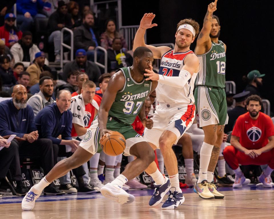 Washington Wizards forward Corey Kispert (24) smacks the face of Detroit Pistons forward Eugene Omoruyi (97) in the first quarter at Little Caesars Arena in Detroit on Tuesday, March 7, 2023.