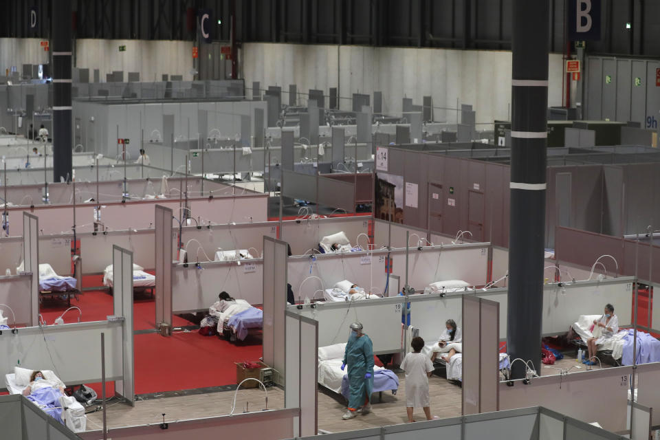 CAPTION CORRECTS THE DATE - This photo taken on Thursday, April 2, 2020 shows a general view of a temporary field hospital set at Ifema convention and exhibition in Madrid, Spain. Most of the 1,850 patients brought to the Ifema field hospital are not in serious conditions. In fact, 800 had been discharged by Thursday, although six had died since doors opened 12 days ago. The new coronavirus causes mild or moderate symptoms for most people, but for some, especially older adults and people with existing health problems, it can cause more severe illness or death. (AP Photo/Manu Fernandez)