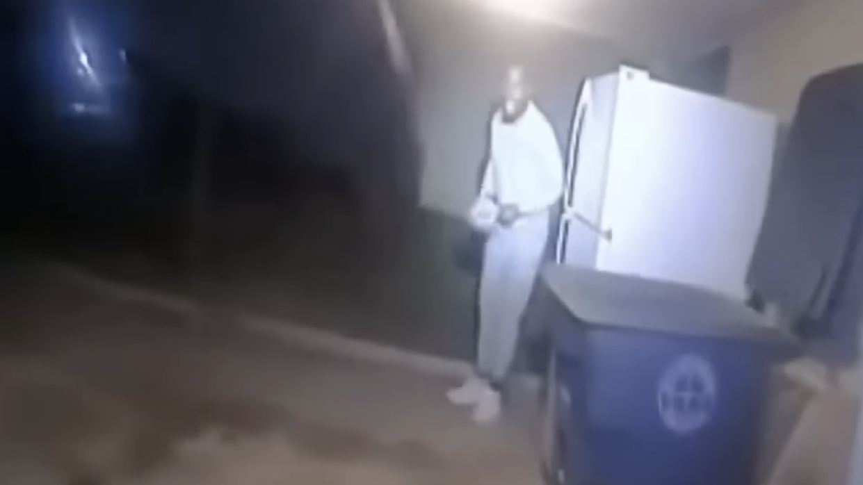 Body camera footage released by the Lawton Police Departmentshows Sanders appeared from around a refrigerator, his hands visible and appearing to holding a ball cap. (Screenshot: YouTube – NBC News)