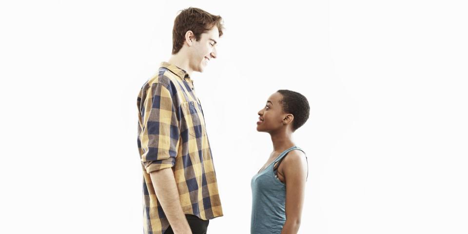 side view studio portrait showing contrasting height of young couple