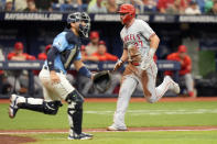 Los Angeles Angels' Mike Trout (27) scores behind Tampa Bay Rays catcher Rene Pinto on a sacrifice fly by Miguel Sano off starting pitcher Ryan Pepiot during the sixth inning of a baseball game Thursday, April 18, 2024, in St. Petersburg, Fla. (AP Photo/Chris O'Meara)