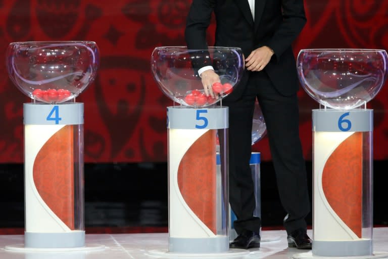 A draw assistant picks a ball during the preliminary draw for the Union of European Football Associations (UEFA) zone for the 2018 World Cup qualifiers at the Konstantin Palace in Saint Petersburg on July 25, 2015