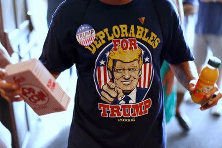 A supporter of Republican presidential nominee Donald Trump returns from the concession stand with popcorn at a Trump rally in Toledo, Ohio, U.S., September 21, 2016. REUTERS/Jonathan Ernst/File Photo