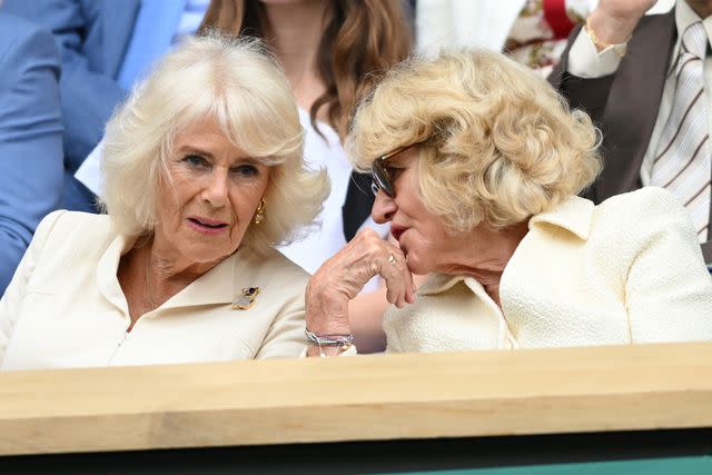 <p>Karwai Tang/WireImage</p> Queen Camilla and Annabel Elliot chat on day 10 of the Wimbledon Tennis Championships at the All England Lawn Tennis and Croquet Club on July 10, 2024.