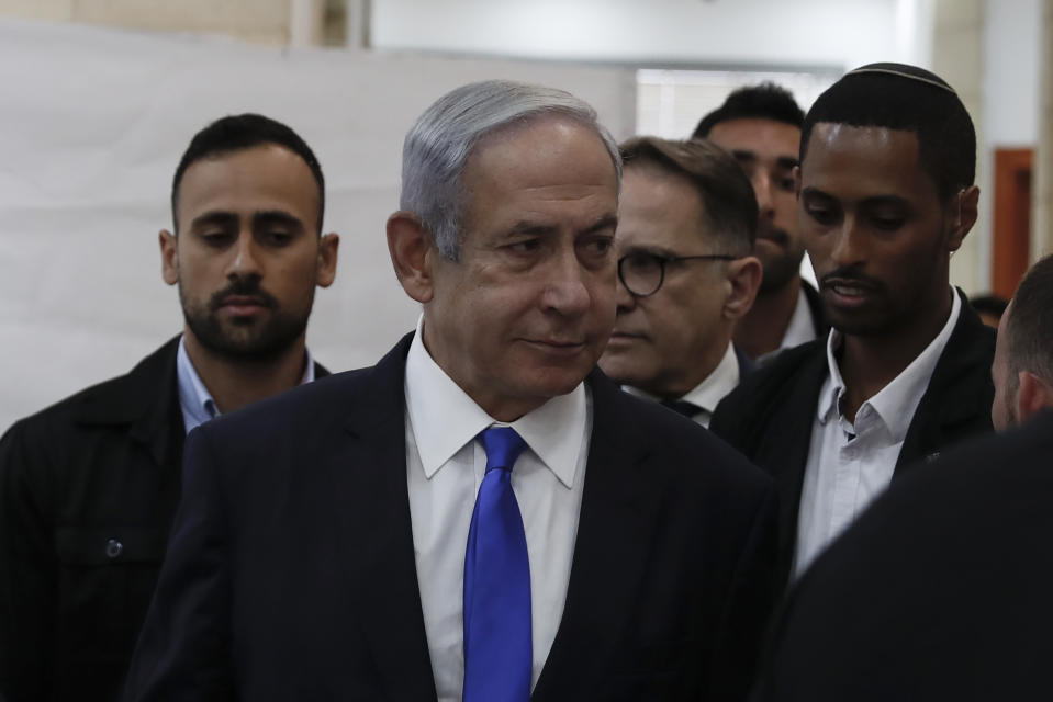 Israeli Prime Minister Benjamin Netanyahu, center, arrives at the District Court in Jerusalem, Israel, Sunday, June 25, 2023. Hollywood producer Arnon Milchan was testifying Sunday at Netanyahu’s corruption trial to answer questions about an alleged “supply line” of champagne and cigars funneled to the Israeli leader and his wife said to have been in exchange for help with Milchan’s personal and business needs. Milchan appeared by videoconference from the English city of Brighton. (Atef Safadi/Pool Photo via AP)
