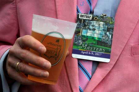 A Masters patron holds a beer during first round play at the 2017 Masters golf tournament at Augusta National Golf Club in Augusta, Georgia, U.S., April 6, 2017. REUTERS/Jonathan Ernst