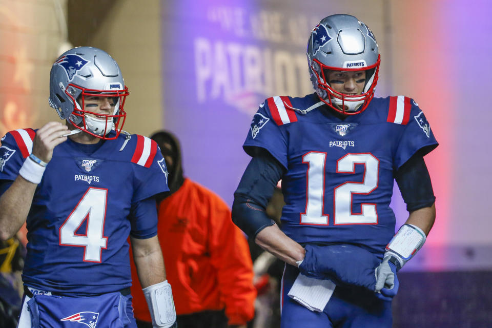 Oct 27, 2019; Foxborough, MA, USA; New England Patriots quarterback Jarrett Stidham (4) and quarterback Tom Brady (12) take the field before the game at Gillette Stadium. Mandatory Credit: Greg M. Cooper-USA TODAY Sports