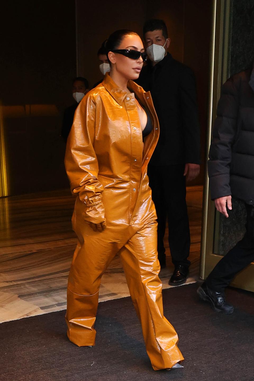 Kim Kardashian wore a baggy orange Prada jumpsuit during Milan Fashion Week on February 23, 2022.