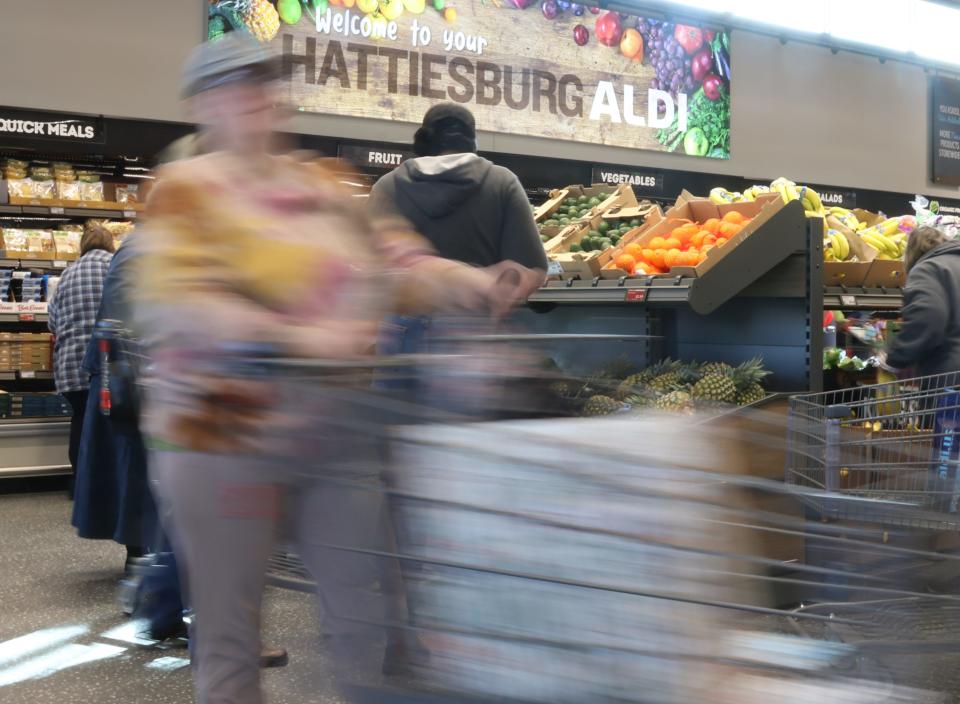 Shoppers stroll through the produce aisle during the opening of the new ALDI in Hattiesburg on Thursday.