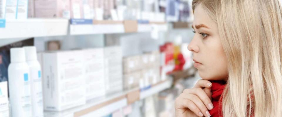 Smart shopping. Close up cropped profile shot of a beautiful young woman choosing products.