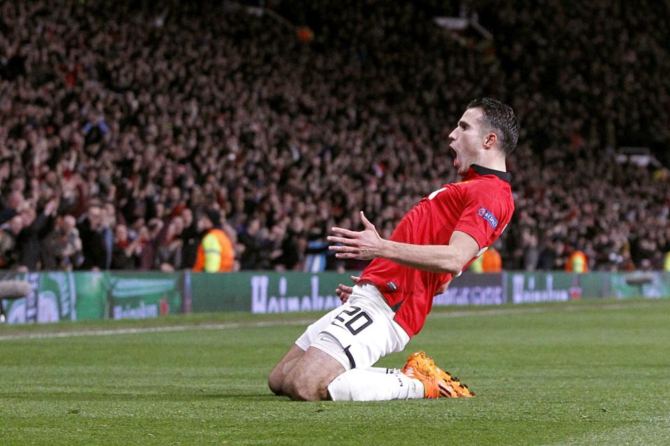 Manchester United's Robin van Persie celebrates scoring his side's third goal and his hat-trick, during the Champions League, Round of 16, second leg match against Olympiakos, at Old Trafford, Manchester, England, Wednesday March 19, 2014. (AP Photo /PA, Peter Byrne) UNITED KINGDOM OUT