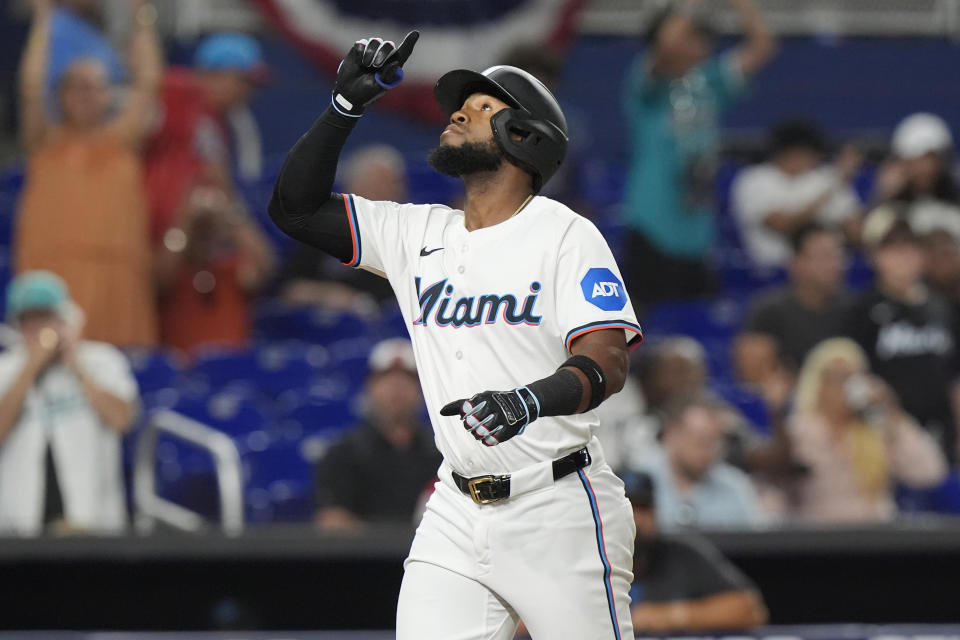 Miami Marlins' Bryan De La Cruz (14) gestures after hitting a home run during the ninth inning of a baseball game against the Los Angeles Angels, Tuesday, April 2, 2024, in Miami. (AP Photo/Marta Lavandier)