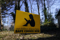 A sign that reads "our children deserve better safe choice now" is seen on Friday, Jan. 15, 2021, in Decatur, Ga. Just down the road from the U.S. Centers for Disease Control and Prevention, in a community flush with resident health professionals, the Decatur school system had no shortage of expert input on whether to resume in-person classes amid the coronavirus pandemic. Scores of public health and medical professionals from the affluent, politically liberal Atlanta suburb have weighed in about what's best for their own kids’ schools.(AP Photo/Brynn Anderson)