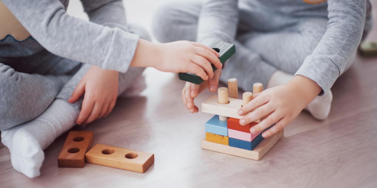 kids playing with wood blocks buy fewer toys make sustainable