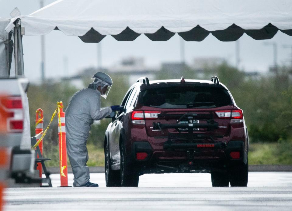 People are tested for COVID-19 at a mobile clinic set up in the parking lot at the Mayo Clinic Hospital in Phoenix on March 18.