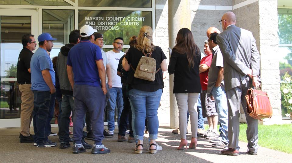 A group of family members and friends stand outside the Marion County Court Annex after Lincoln Smith was arraigned on Friday for charges stemming from a Thursday crash that resulted in the death of seven people on I-5 south of Salem.