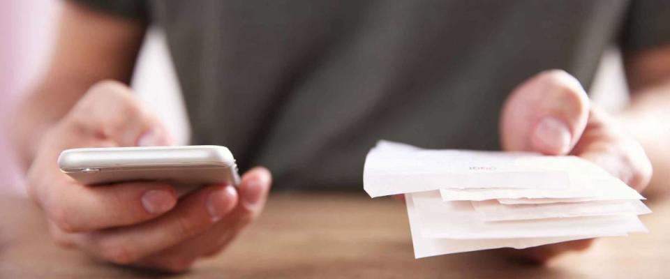 Male hands using calculator apps at the table