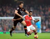 <p>Arsenal’s Theo Walcott and Hull City’s Harry Maguire (left) </p>