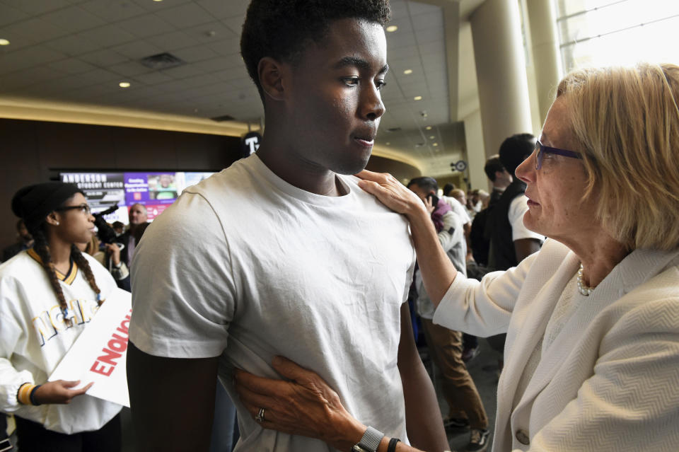 In this Oct. 25, 2018, photo University of St. Thomas president Dr. Julie Sullivan, right, talks to Kevyn Perkins at a protest in Anderson Student Center at the University of St. Thomas in St. Paul, Minn. The protest was in response to a racial slur written on the dorm door of Perkins. (Jean Pieri/Pioneer Press via AP)