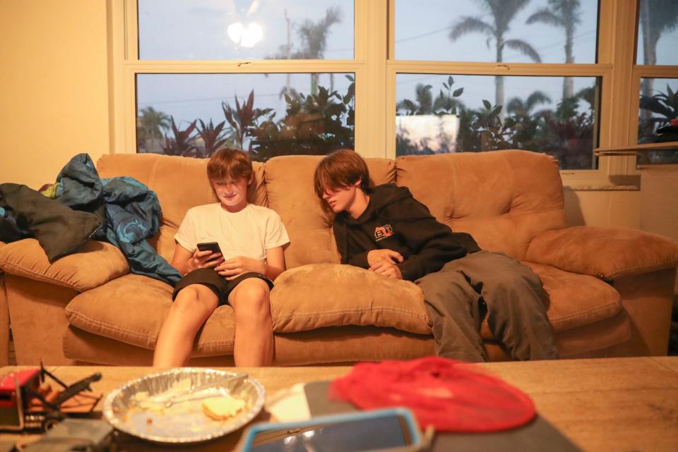 Eli, 12, and Ryder Collins, 14, watch TikToks on Eli's phone at their home in Cape Coral on Monday, Dec. 12, 2022.