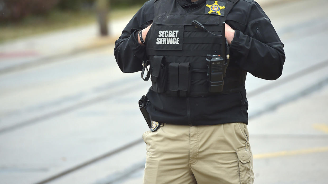 A Secret Service officer stands in front of the Darby (Pa.) Community Center during President Biden's visit there in March 2021.