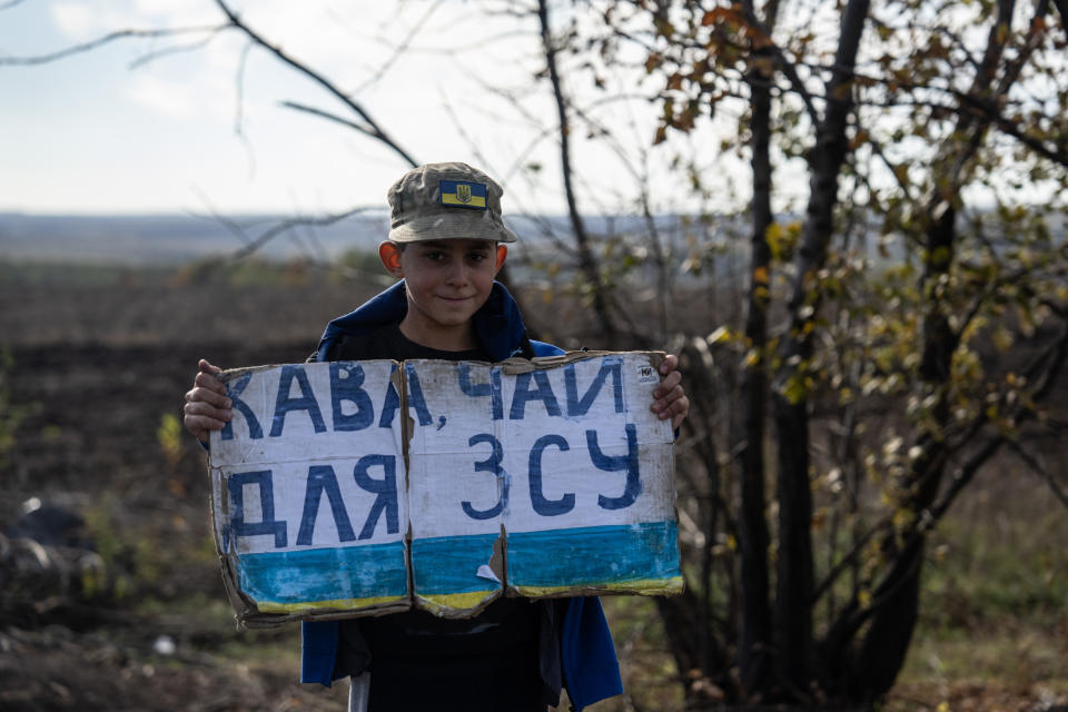DUBOVE, UKRAINE - OCTOBER 19: A boy holds a sign reading 