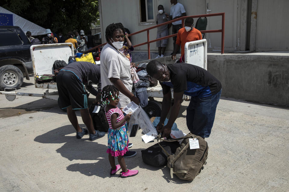 Haitian migrants deported from the US gather after their arrival to the Toussaint Louverture International Airport in Port-au-Prince, Haiti, Sunday, Sept. 19, 2021. Thousands of Haitian migrants have been arriving to Del Rio, Texas, to ask for asylum in the U.S., as authorities begin to deported them to back to Haiti. (AP Photo/Rodrigo Abd)