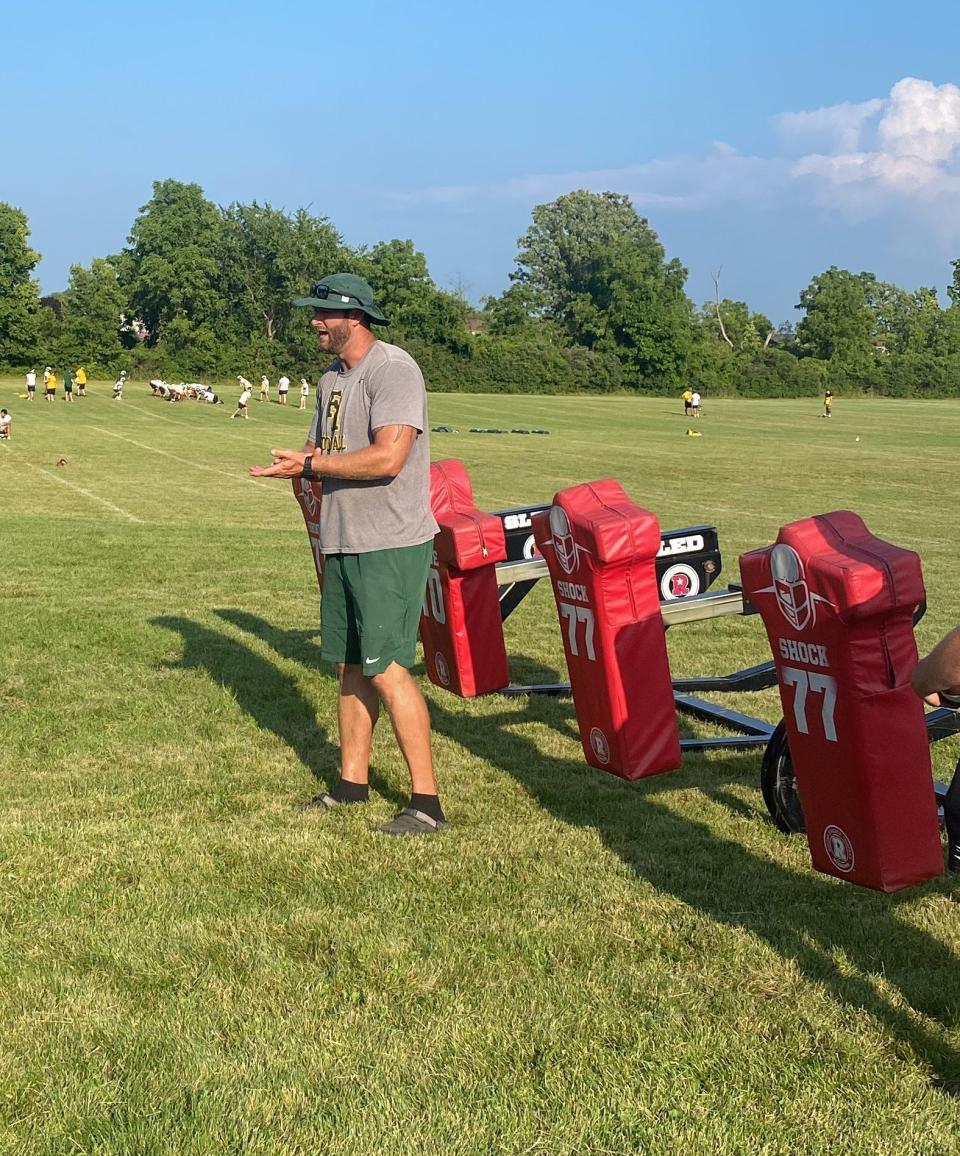 A Flat Rock assistant coach Jeff Zipfel gives instructions during a recent football practice.