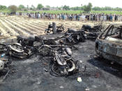 <p>Destroyed vehicles are seen at the site of an overturned oil tanker which caught fire and killed 123 people after the explosion, near the Pakistani city of Bahawalpur in southern Punjab province, on June 25, 2017. (Khan Muhammad/Anadolu Agency/Getty Images) </p>