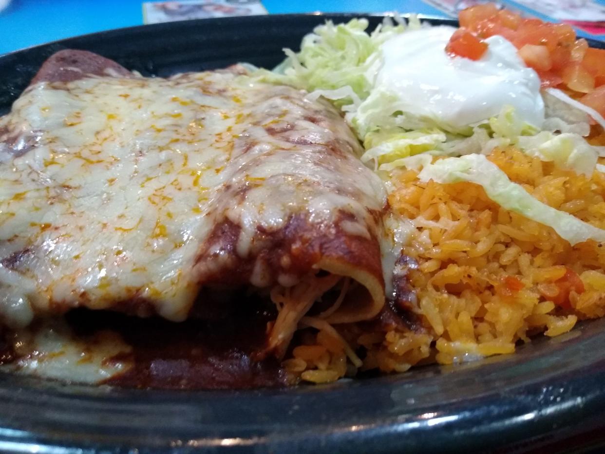 Mucho Bueno’s No. 61 Yolanda’s Enchiladas includes three stuffed chicken enchiladas topped with cheese, lettuce and sour cream and served with a side of rice.