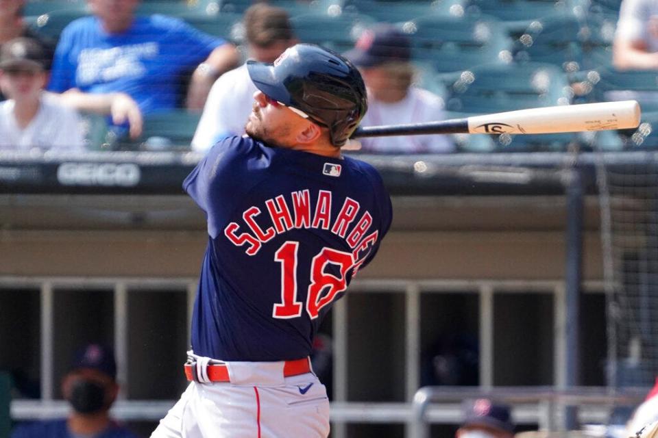 Outfielder Kyle Schwarber of the Red Sox follows the flight of a fly ball against the White Sox.