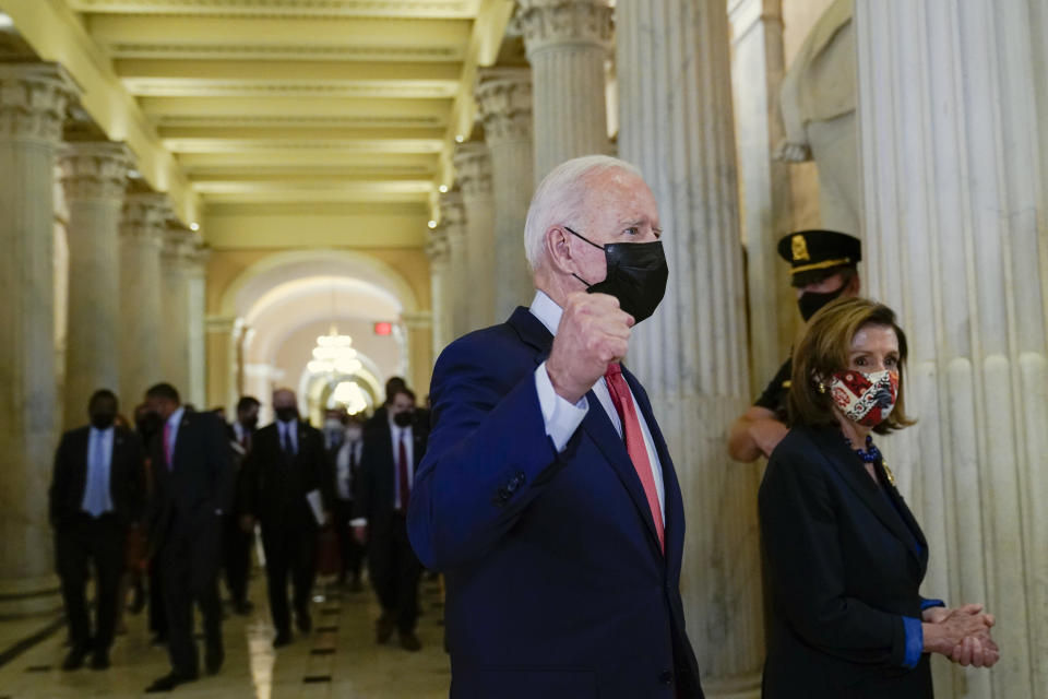 President Joe Biden gestures as he walks with House Speaker Nancy Pelosi of Calif., on Capitol Hill in Washington, Friday, Oct. 1, 2021, after attending a meeting with the House Democratic caucus to try to resolve an impasse around the bipartisan infrastructure bill. (AP Photo/Susan Walsh)