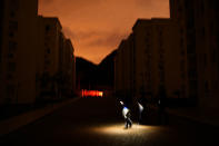 <p>Journalists use their phones to light the way as they walk though a ‘media village’ during an extended black-out in Rio de Janeiro, Brazil during the early hours of August 22, 2016. (Dylan Martinez/Reuters) </p>