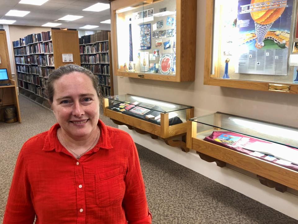 McClung Historical Collection archivist Joanna Bouldin stands near some World’s Fair mementos on display on the third floor in the East Tennessee History Center on July 20, 2022, She helped pull out some items for display on the occasion of the fair’s 40th anniversary.