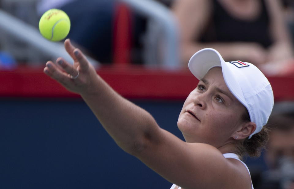 Ashleigh Barty of Australia tosses the ball to serve to Kiki Bertens of the Netherlands during quarter-finals play at the Rogers Cup tennis tournament Friday, Aug. 10, 2018 in Montreal. (Paul Chiasson/The Canadian Press via AP)