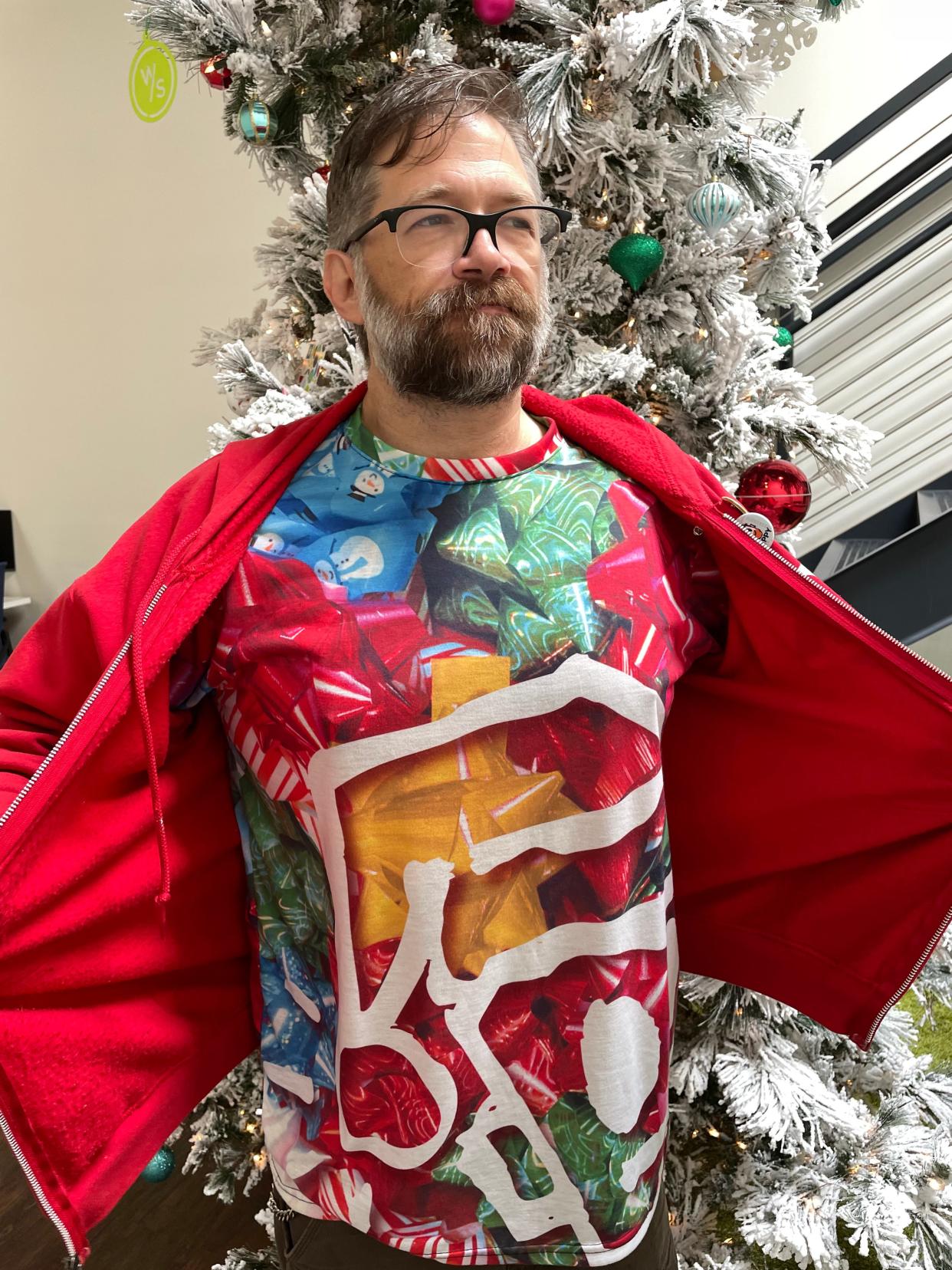 Leonard "Porkchop" Zimmerman, Jr. shows off the holiday shirt he designed which features his beloved character, Happy the robot.