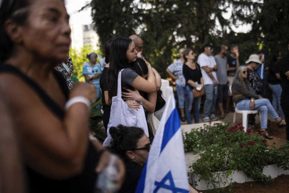 Mourners attend the funeral of Dana Bachar and her son Carmel , at Gan Shlomo cemetery, central Israel, Tuesday, Oct. 24, 2023. Carmel Bachar, 15-year-old and his mother Dana lived in kibbutz Be'eri, a small community with a little more than 1,000 people, that was one of more than 20 towns and villages ambushed on Oct. 7 as part of a surprise attack by Hamas militants against Israel where dozens were killed.(AP Photo/Petros Giannakouris)