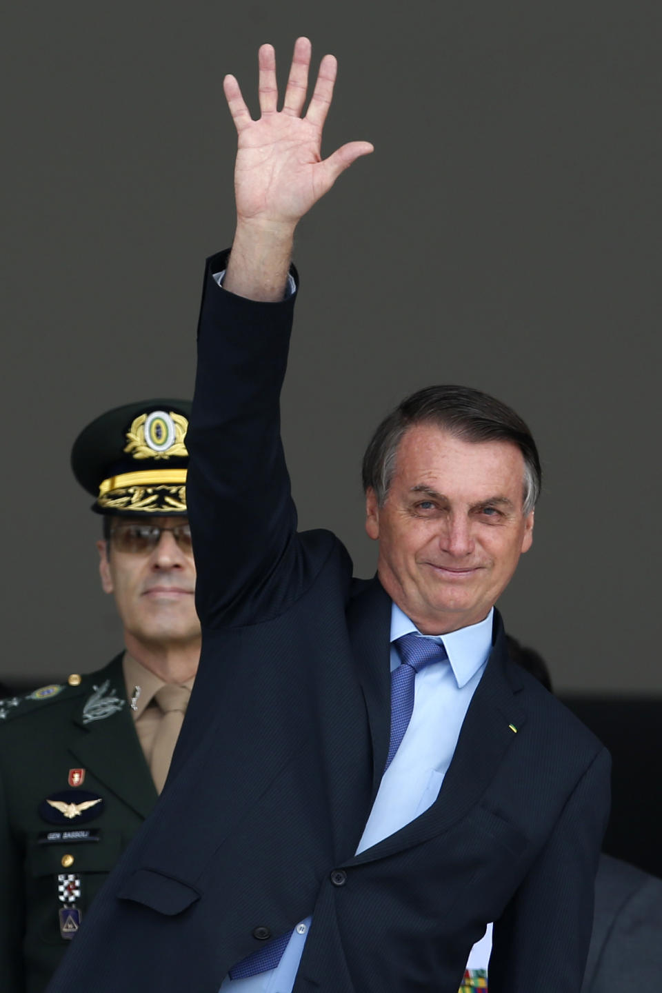 Brazil's President Jair Bolsonaro waves during a Changing of the Guard at the Planalto Presidential Palace, in Brasilia, Brazil, Thursday, Nov. 28, 2019. (AP Photo/Eraldo Peres)