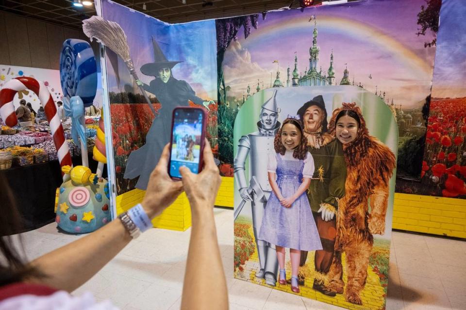 Phetmany Whittlesey, 12, center, and Elea Cacal, 13, right, pose for a photograph in a scene from “The Wizard of Oz” at the candy maze selfie experience at the California State Fair on Wednesday.