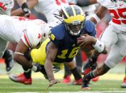 Denard Robinson #16 of the Michigan Wolverines dives for extra yards past C.J. Barnett #4 of the Ohio State Buckeyes at Michigan Stadium on November 26, 2011 in Ann Arbor, Michigan. Michigan won the game 40-34. (Photo by Gregory Shamus/Getty Images)