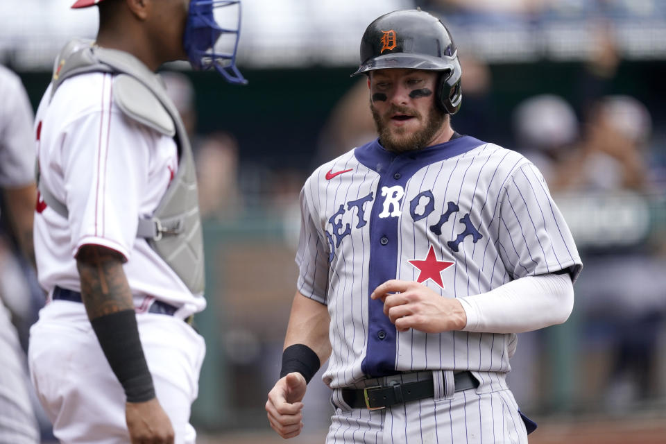 Detroit Tigers' Robbie Grossman runs home to score on an RBI single by Jeimer Candelario during the first inning of a baseball game Sunday, May 23, 2021, in Kansas City, Mo. (AP Photo/Charlie Riedel)