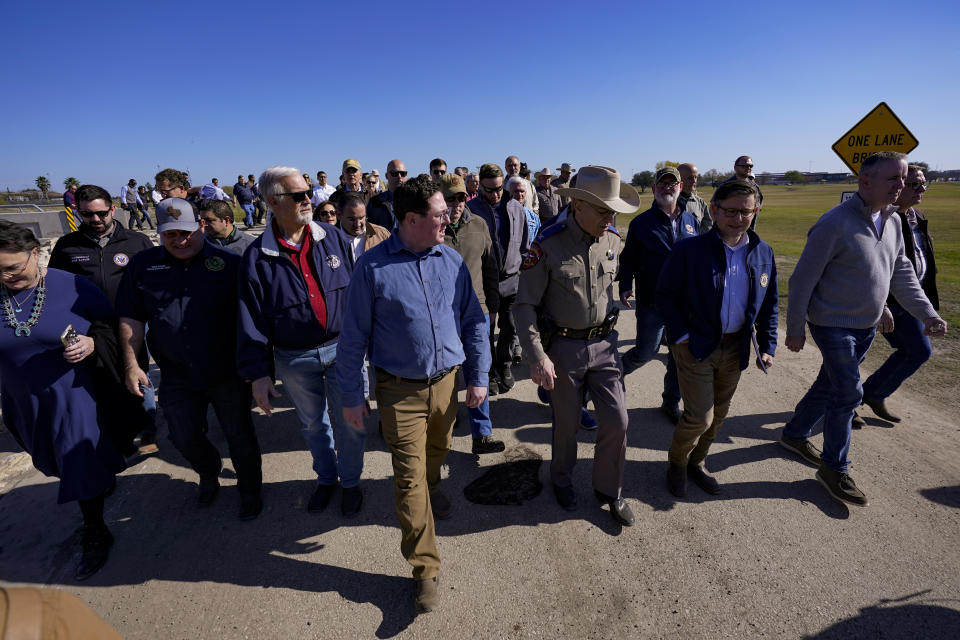 Republican members of Congress walk adjacent to the Rio Grande at the Texas-Mexico border, Wednesday, Jan. 3, 2024, in Eagle Pass, Texas. U.S. House Speaker Mike Johnson is leading about 60 fellow Republicans in Congress on a visit to the Mexican border. Their trip comes as they are demanding hard-line immigration policies in exchange for backing President Joe Biden's emergency wartime funding request for Ukraine. (AP Photo/Eric Gay)