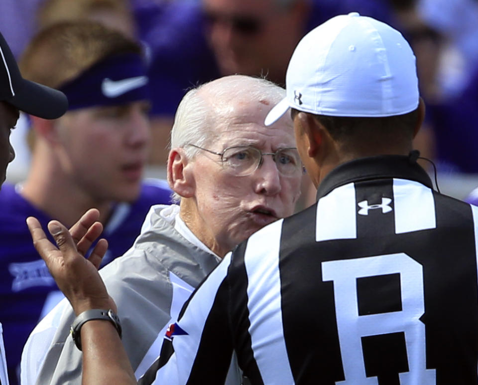 Kansas State head coach Bill Snyder talks with referee Reggie Smith after Cre Moore’s ejection for targeting. (AP Photo)